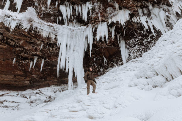 Photographers exploring a frozen waterfall