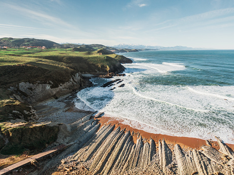 A beautiful beach surrounded of green grass land in Cantabria, a region in the north of Spain.