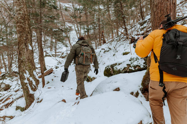 istock Photographers exploring a frozen waterfall 1196058983
