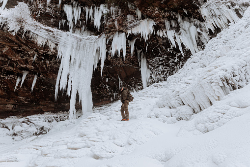 Photographers exploring a frozen waterfall