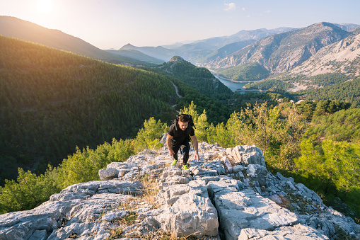 A mountain climber reaching the top of a mountain