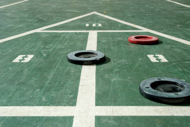 This picture shows shuffleboard pucks and a court. This court was found at a resort hotel.