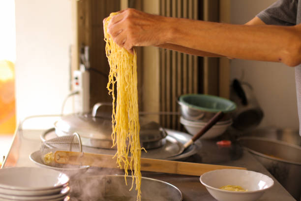 istock Old man arm make Khao soi is Thai north noodle 1196060360