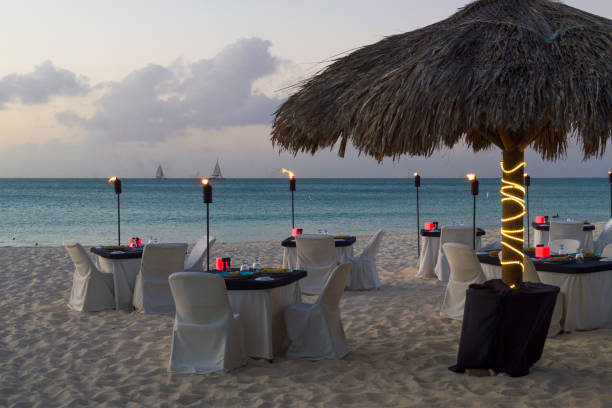 istock Luxury Evening Dining on White Sand Beach Paradise 1196060470