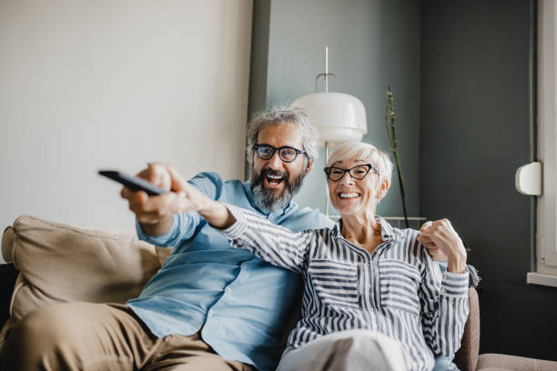 istock Senior couple at home watching TV 1196061606