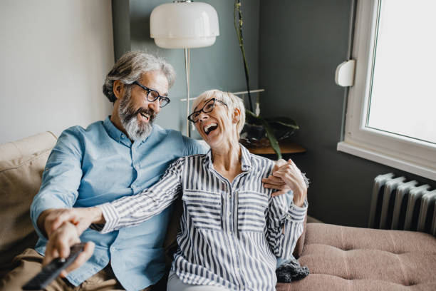 istock Senior couple at home watching TV 1196061614