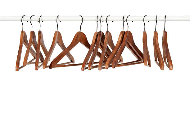 Many wooden hangers on a rod stock photo