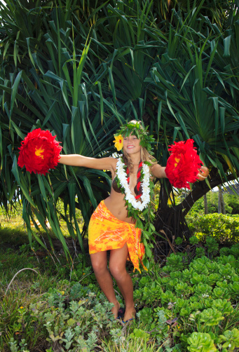 Eight year girl dressed in an Hula Dancers outfit on white background