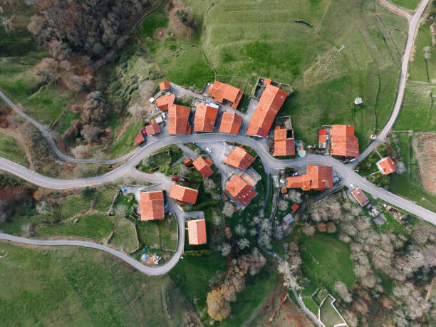 Russian village at a flat terrain among agricultural fields. A sunny summer day at Mari Republic, Volga Region, Russia. A bird's eye view