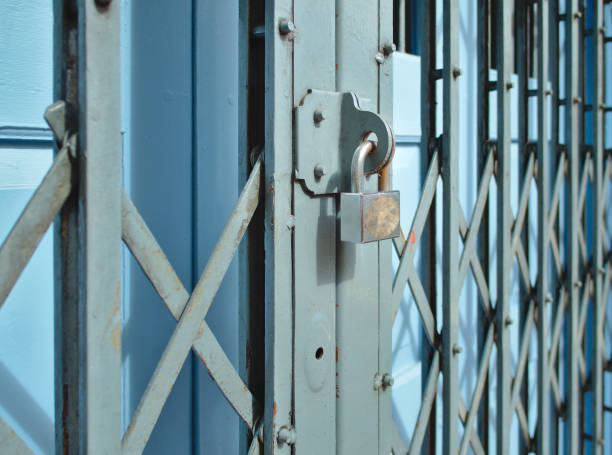 istock Old silver lock on iron sliding door and vintage metallic gate 1196064585