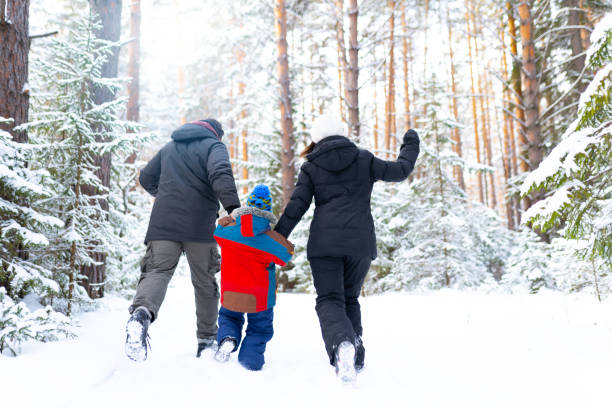 istock Family running in winter forest 1196065824