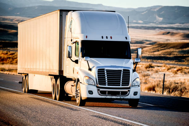 istock Long Haul Semi-Truck Rolling Down a Four-Lane Highway at Dusk 1196066080
