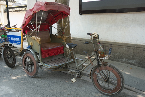 Suzhou,China-September 17, 2019: Traditional Chinese touring cycle rickshaw in Suzhou, China