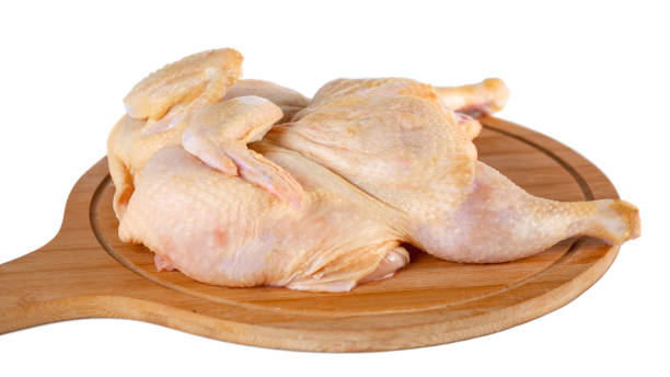 istock whole raw chicken on wooden cutting board isolated on white background 1196069082
