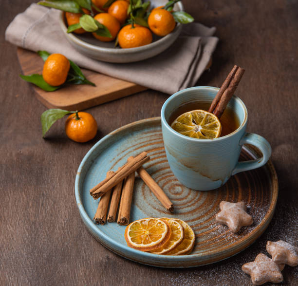 istock tea with tangerine and cinnamon with gingerbread on a wooden table 1196069807