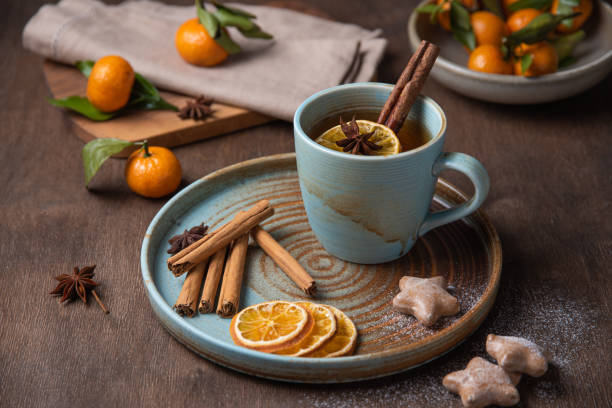 istock tea with tangerine and cinnamon with gingerbread on a wooden table 1196069814