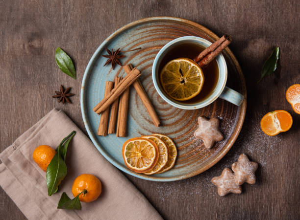 istock tea with tangerine and cinnamon with gingerbread on a wooden table 1196069823