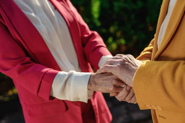 istock Elderly couple connecting hands outdoors stock photo 1196069965