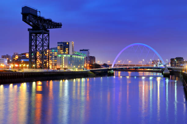 Finnieston Crane and The Clyde Arc, River Clyde, Glasgow, Scotland, UK Wide angle view of the Finnieston Crane and The Clyde Arc on the banks of the River Clyde at dusk. Glasgow, Scotland, UK, Europe. clear sky night sunset riverbank stock pictures, royalty-free photos & images