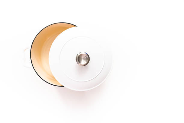 istock White enameled cast iron covered round dutch oven on a whjite background. 1196072484