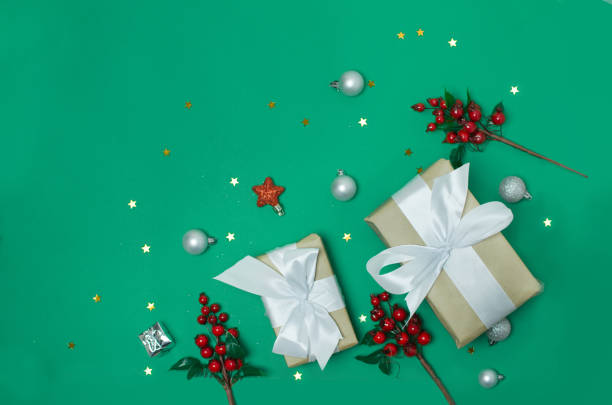 istock Christmas presents and decorations on green background 1196073216