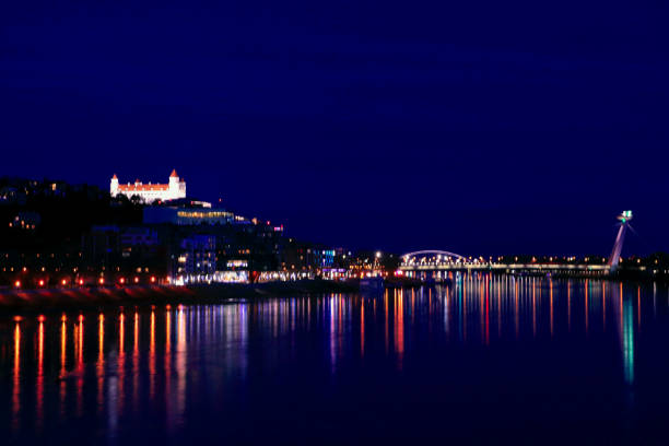 Evening Bratislava is reflected in the water of the Danube river Evening luminous Bratislava is reflected in the water of the Danube river former czechoslovakia stock pictures, royalty-free photos & images