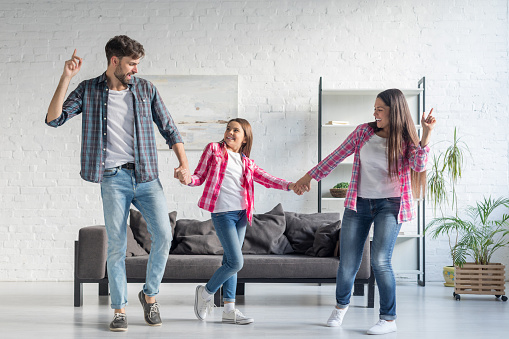 Happy family dancing at home