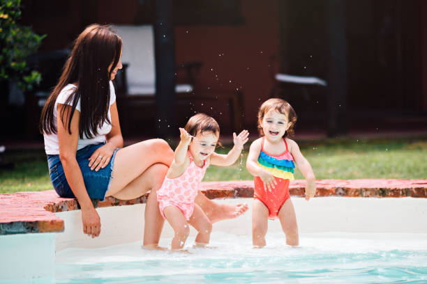 istock Family at swimming pool 1196076985
