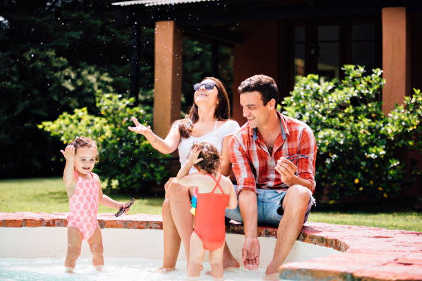 istock Family at swimming pool 1196077090
