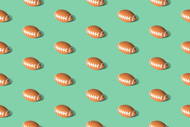 Football pattern texture on grass abstract. American football ball pattern on green background minimal creative sport concept. pigskin stock pictures, royalty-free photos & images