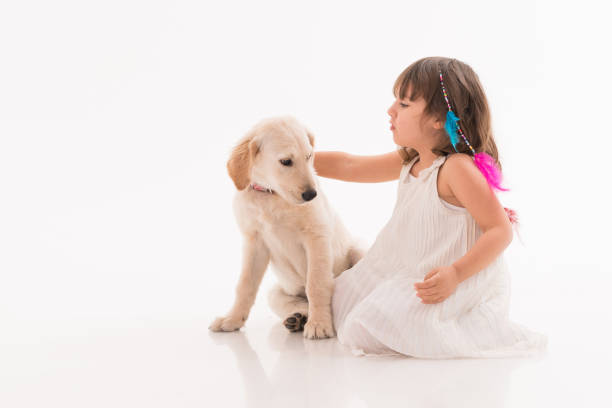 istock Happy girl wit his dog over white background 1196079140