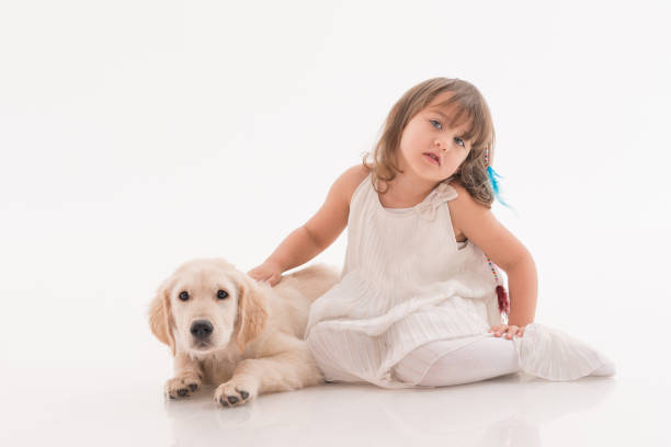 istock Happy girl playing with his dog on a white 1196079405