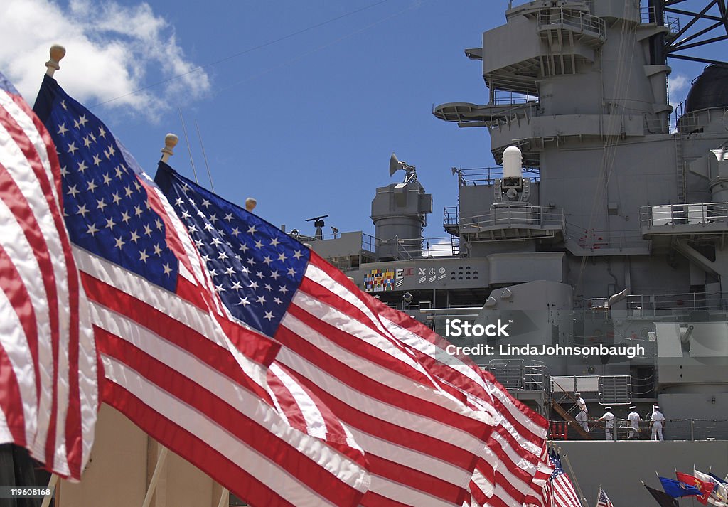 US Flags Beside Battleship Missouri Memorial with Four Sailors  US Navy Stock Photo