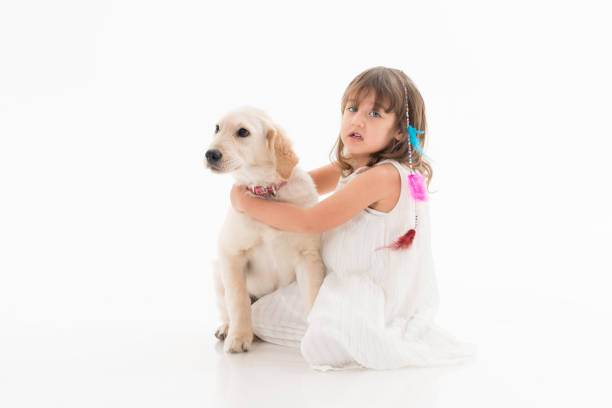 istock Happy girl playing with his dog on a white 1196083045