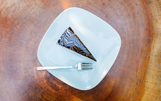 Slice of chocolate cake on wooden table