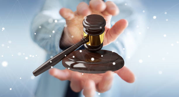Businessman on blurred background with justice hammer 3D rendering
