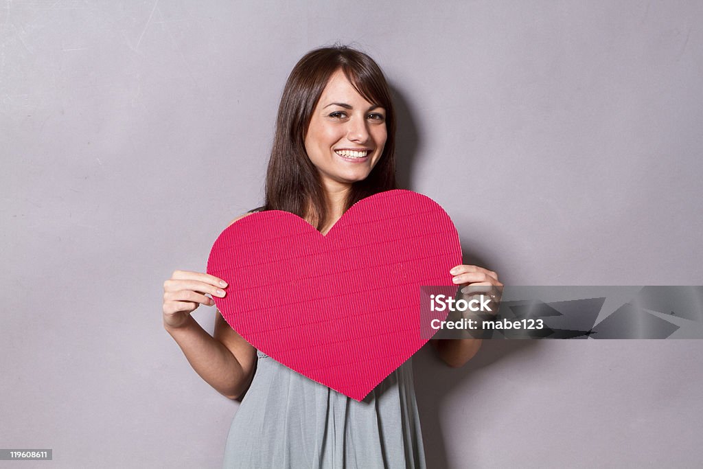 Young woman holds a big red paper heart Woman with Heart Heart Shape Stock Photo