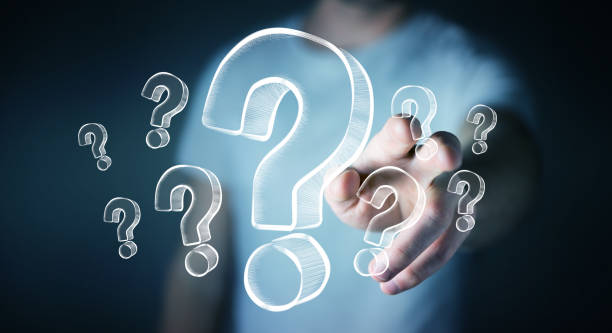 Businessman on blurred background touching hand drawn question marks