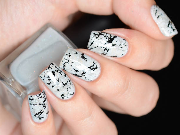 istock grey manicure with marblre effect with shimmer on a black background 1196088784