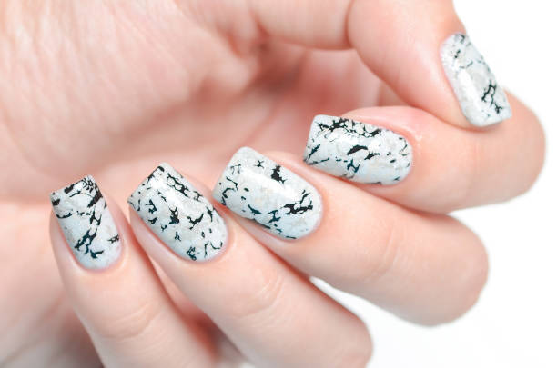 istock grey manicure with marblre effect with shimmer on a white background 1196088827