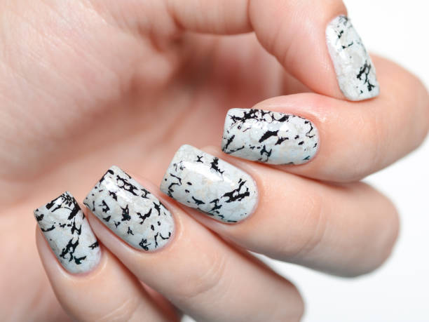 istock grey manicure with marblre effect with shimmer on a white background 1196088867