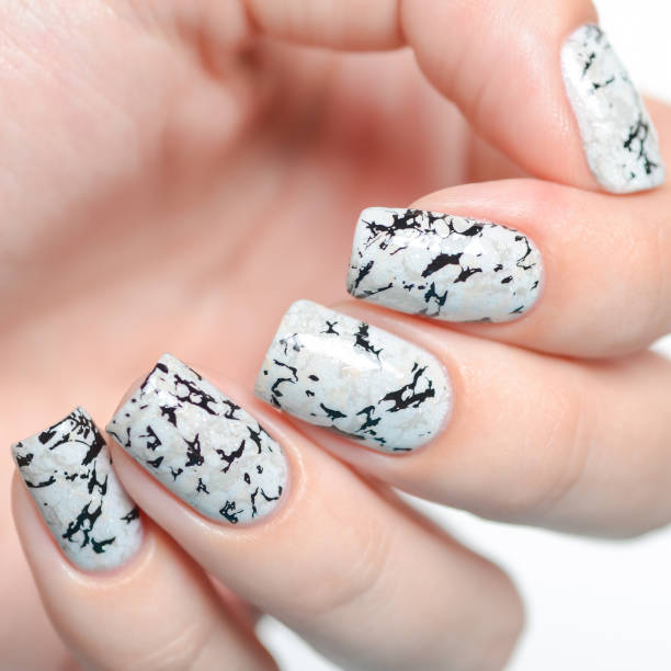 istock grey manicure with marblre effect with shimmer on a white background 1196088882