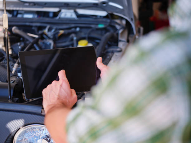 istock Man Using a Digital Tablet to Repair a Car 1196090595