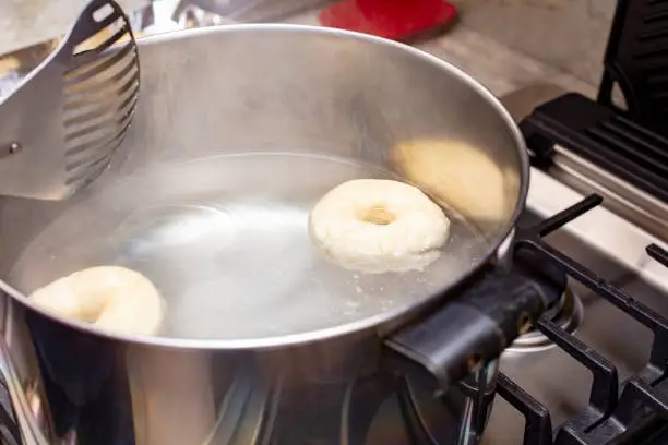 Homemade process of boiling homemade bagels in a pan of water