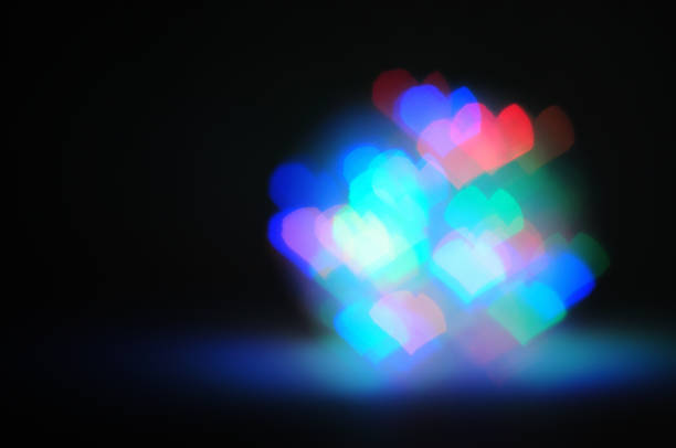 Hearts bokeh of garland LED light bulbs on a black background