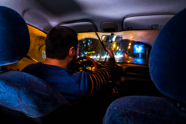 istock Angry Man driving car at night 1196098728