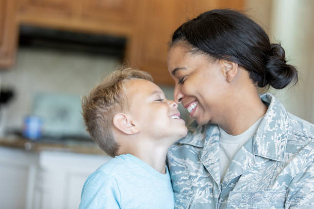 Army mom and young son being affectionate