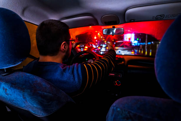 istock Angry Man driving car at night 1196098976