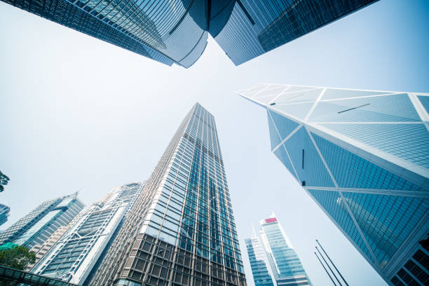 Skyscraper highrise cityscape modern urban downtown towers Gleaming glass and steel citadels of commerce stretching into the blue sky above Hong Kong's crowded Central District, China. central district hong kong stock pictures, royalty-free photos & images