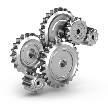 solving the problem concept - puzzles and cogwheels. wooden gears under the puzzle, the concept of moving to the next level. Cog wheels coming out from underneath a jigsaw puzzle.